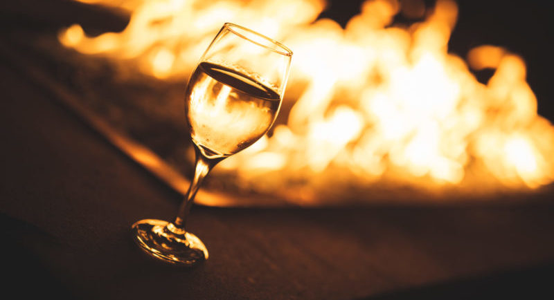 wine glass in front of fireplace