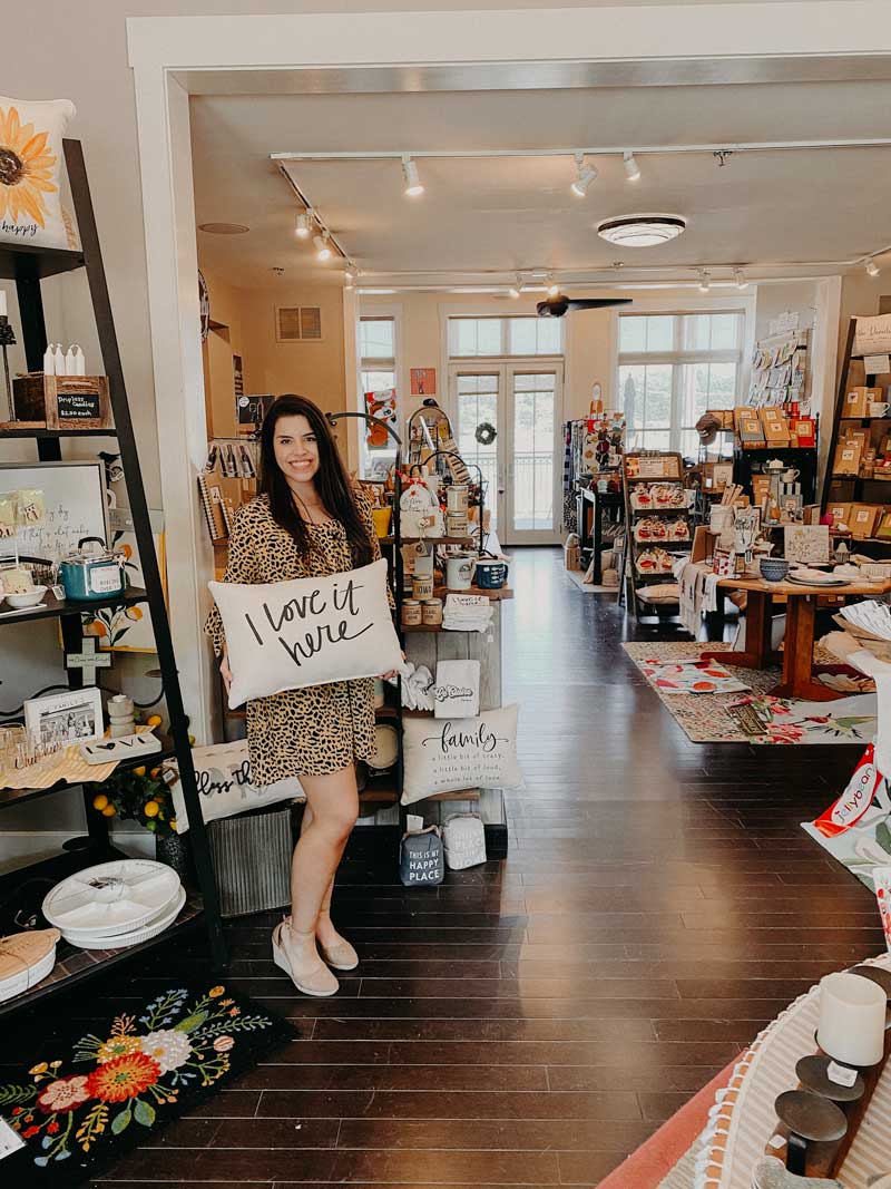 woman holding a pillow in a gift shop