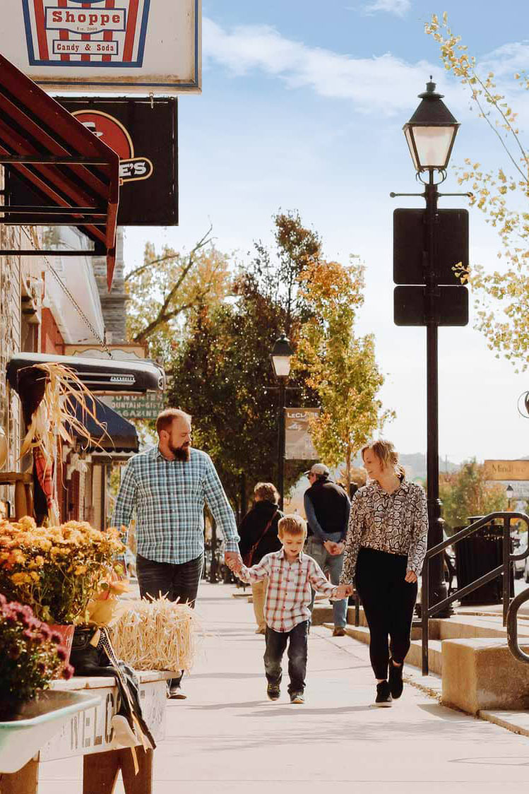 A family walking down Cody Road in fall.